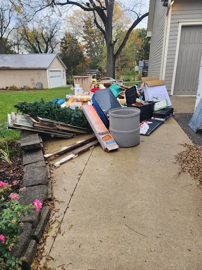 Dumpster being loaded with debris for Roofing Dumpster Rental in Primera